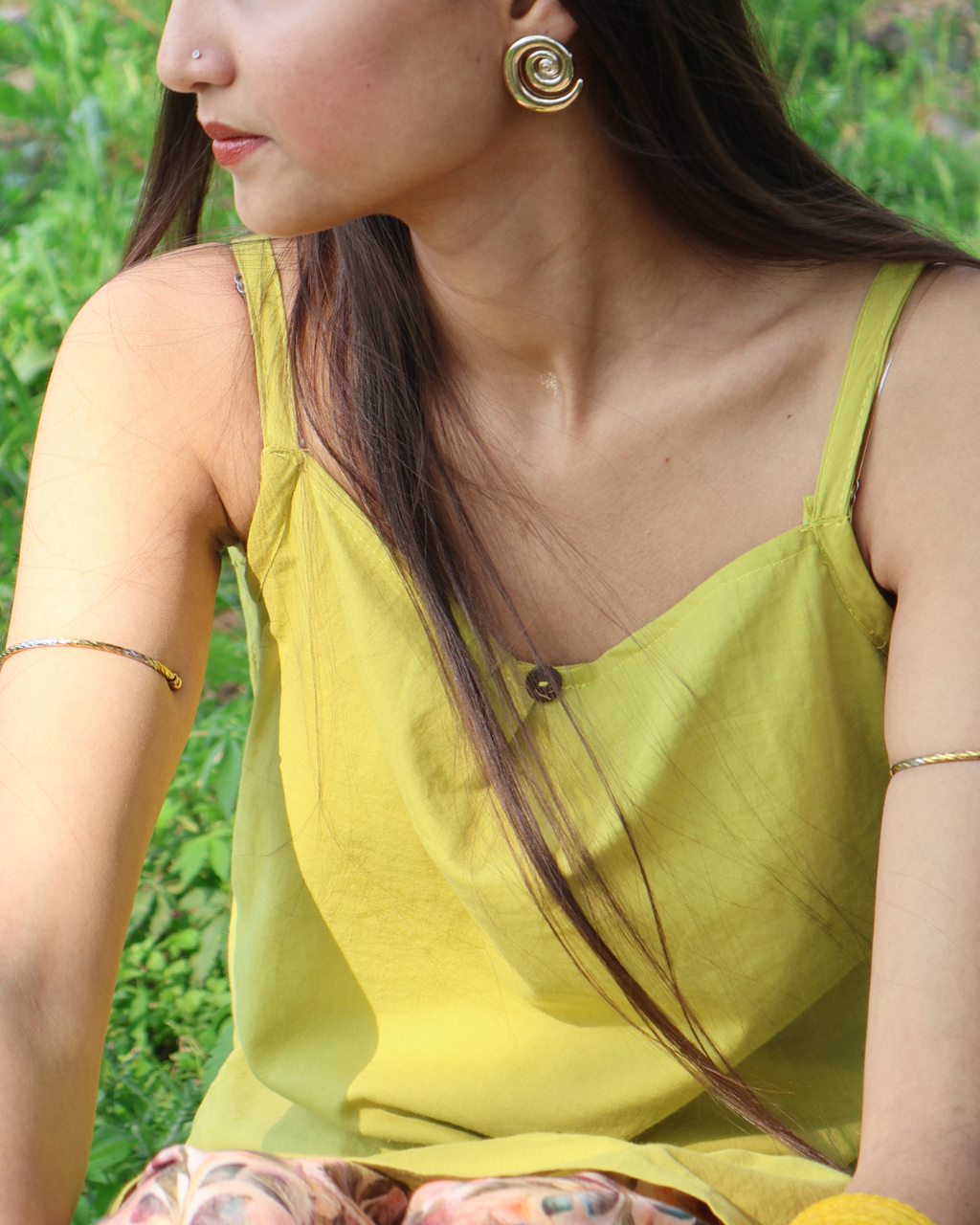 Woman wearing a yellow top with a green background