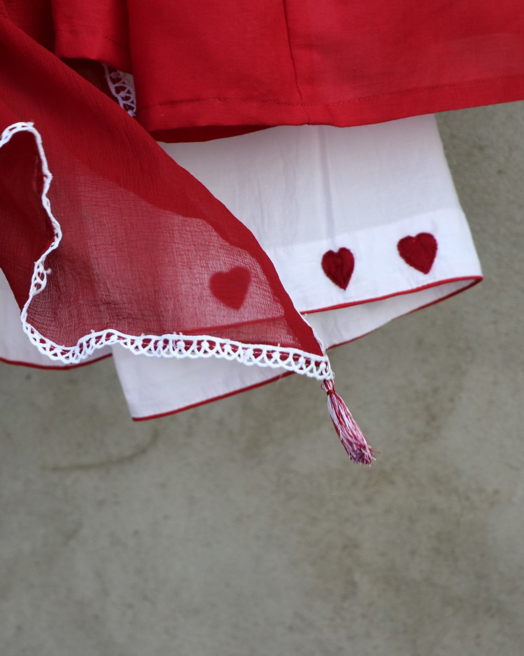 Red and white fabric with heart patterns on a neutral background
